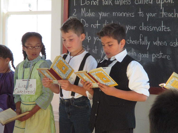 Students standing, reading from books